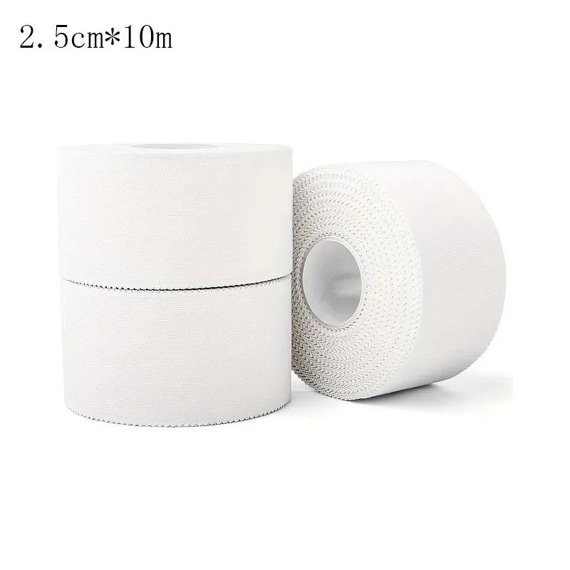 White athletic trainer tape roll pair with one loose roll angled in foreground