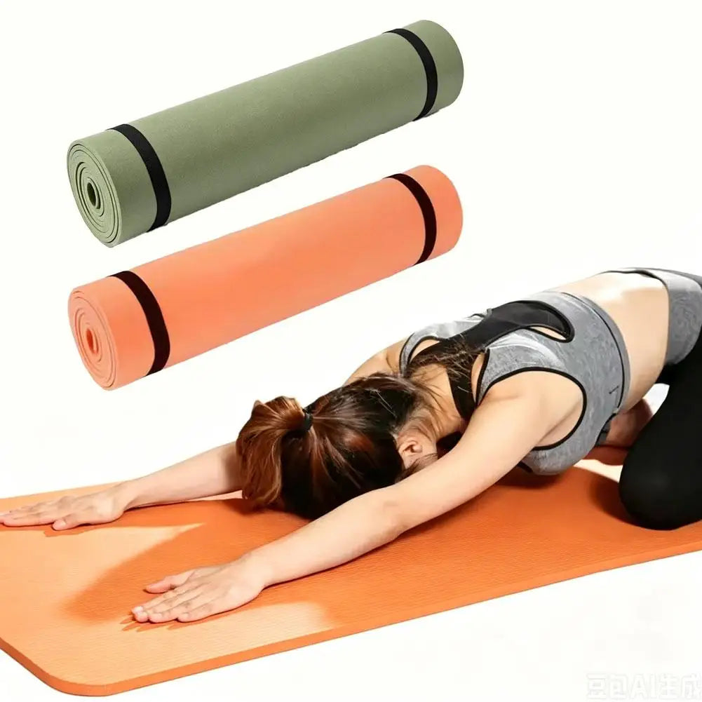 Orange yoga mat with rolled olive and orange mats beside it, woman on mat