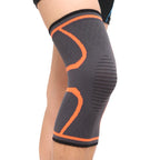 Black knee sleeve with orange support bands and ribbed compression texture.