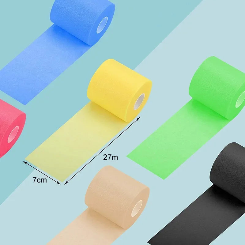 Foam underwrap tape rolls in blue, yellow, green, tan, and black; tape strips laid out