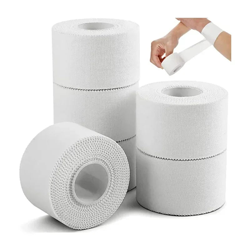 White cotton athletic trainer tape rolls, three rolls with loose tape end