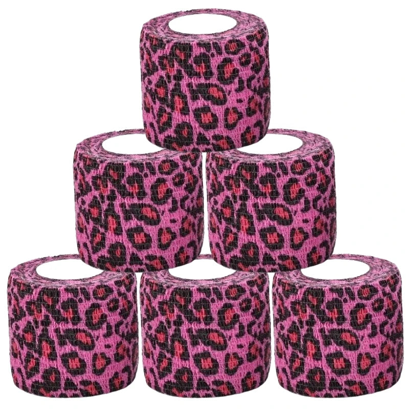 Stacked pink leopard-print self-adhesive wrist bandage rolls